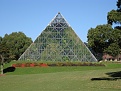 Funky pyramid that says "Sex and Death" underneath, in the topiary.