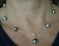 Kamoka silver circle'  on beading wire.