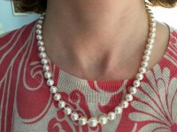 The strand is made up of 6.5-8.5mm graduated metallic freshwater pearls. The studs are 9-10mm metallic fwp.