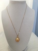 golden South Sea pendant from Golay Singapore on bust