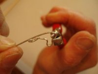 Pulling wire around pliers at red mark to form heart shape.jpg