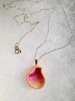 pearl, cut in half, and filled with sapphires. The back is also a beautiful lustrous peachy-pink little h