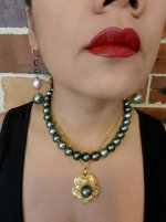 Cees strand layered with my gold flower pendant and my long dangle earrings close up