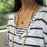 wearing white and gold south sea strand with golden pearl pendant close up