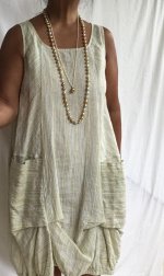 wearing white and gold south sea strand with golden pearl pendant with dress