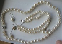 Pearl Paradise 18 necklace of 8.5-9mm pearls, a double strand of 6.5-7mm for the bracelet, and 10mm drop earrings with an accent diamond