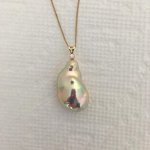 Metallic souffle pearl with exotic colors set with a diamond