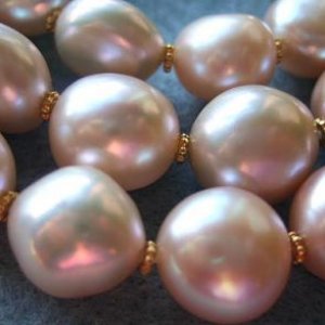 Close Up Of Large Peach Baroque Freswater Pearls With 14 Carat Gold Accent Beads