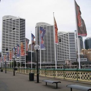 Flags on the other side of the footbridge. Monorail tracks are you can see.