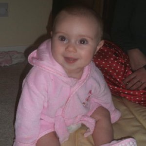 Six and a half months old and sitting up on her own, albeit a little wobbly.