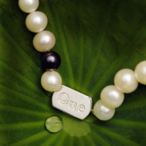 "One World" pearl necklace on lotus leaf