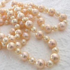 My Old Akoya with Golden Apricots. I bought my akoyas about 30 years ago and don't wear them any more. So I've restrung them with 10mm golden apricot almost round freshwater pearls. Its maybe 36 inches long now, with matching earrings. I wore them to the Christmas party 2008.