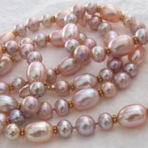 PinkandLilacMixedNecklace - with gold daisy spacers. 32 inch, pink plump rice 12x8mm, small lilac 6mm & 7mm.
These pearls are HIGH SHINE!