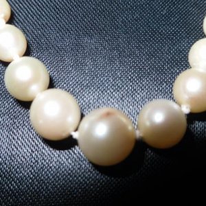 Showing discoloration on largest pearl