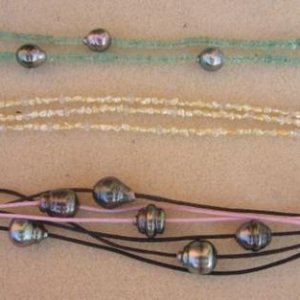 bracelets, from the top: Emerald with Tahitians, Akoya keshi with morganite, waxed cotton with Tahitians.