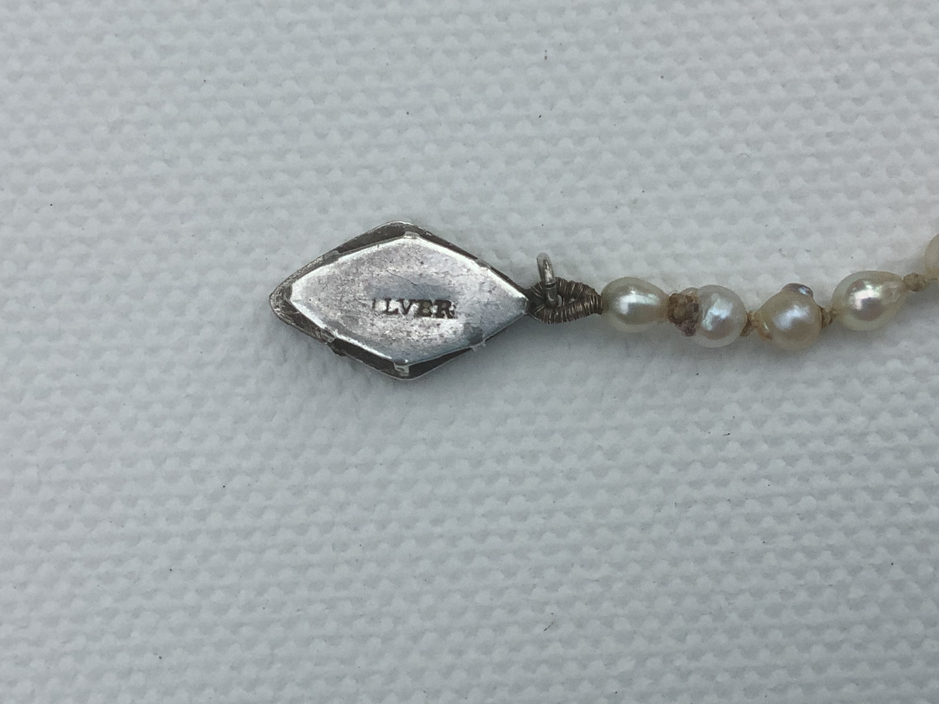 Lettering on clasp looks like an old stamp