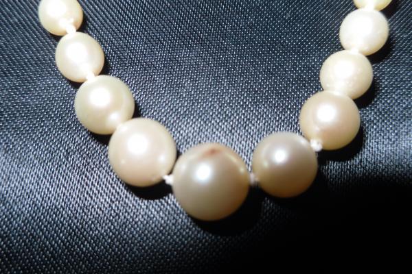 Showing discoloration on largest pearl