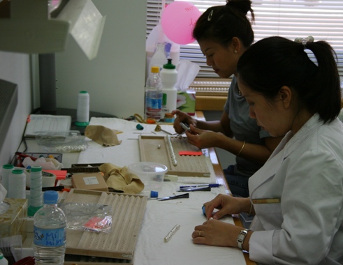 Stringing pearls at Paspaley's sorting facility.