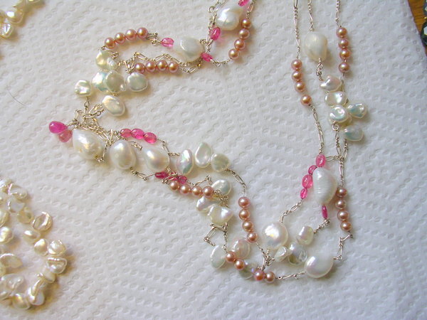 very long silver necklace with small pink pearls, keshi petals, white baroques and pink sapphires and spinels